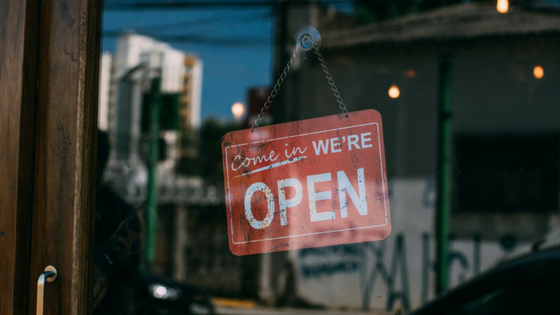 An Open sign displayed in the window of a business
